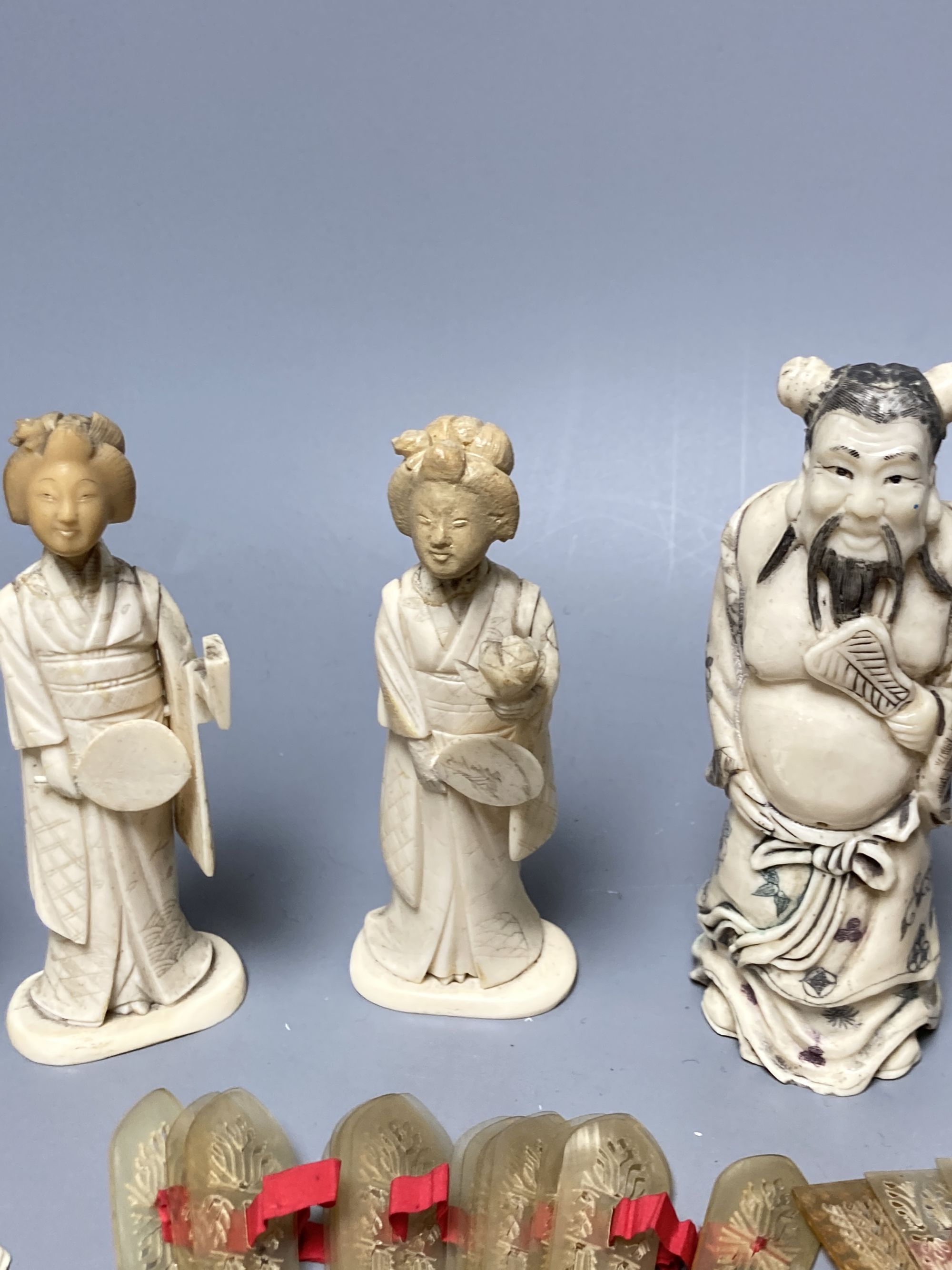A quantity of bone and ivory carvings including fans and figures
